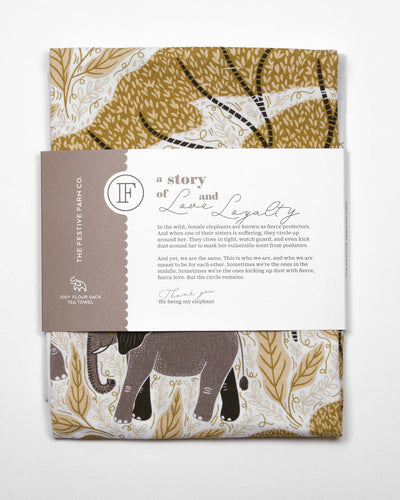 Elephant Print Tea Towel packaged with a belly band telling the story of Sisterhood, Love, and Loyalty, and how we are like elephants in the wild when we circle around our sisters.